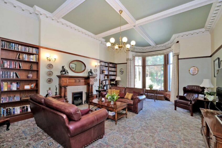 Lounge with pitch pine woodwork and doors, ornate plasterwork cornices, ceilings and friezes.