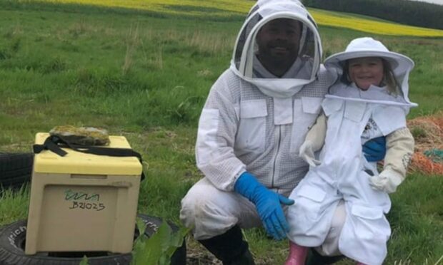 Brian Gall and Marla with the bee hive that was stolen. Picture by Cove Honey Bees.