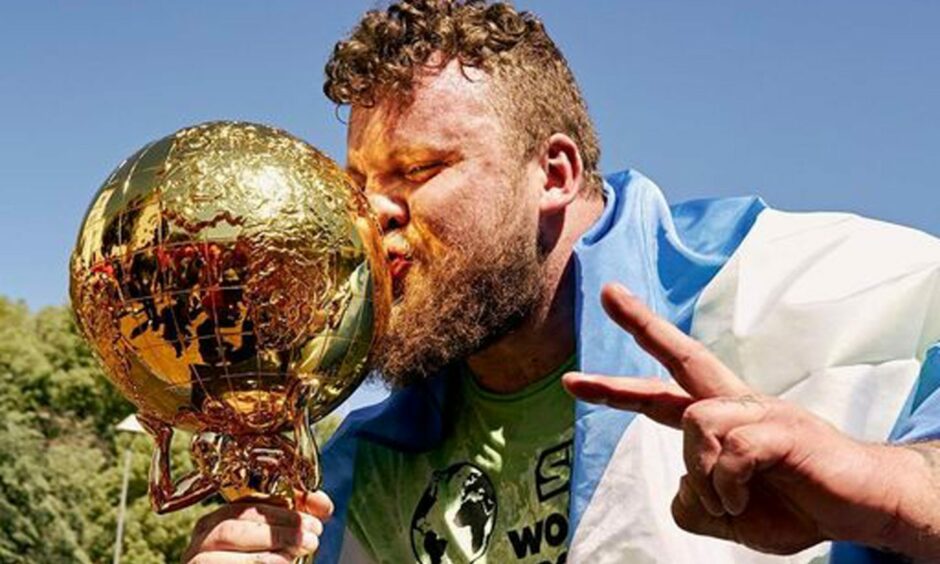 Tom Stoltman lifts the World's Strongest Man trophy for a second time.
