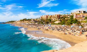 Tenerife beach with buildings in the background.