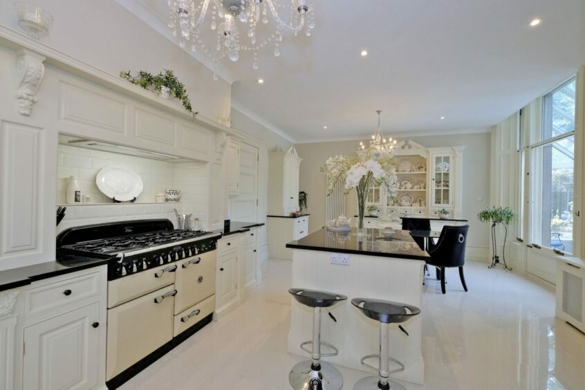 White kitchen and dining area with black accents.