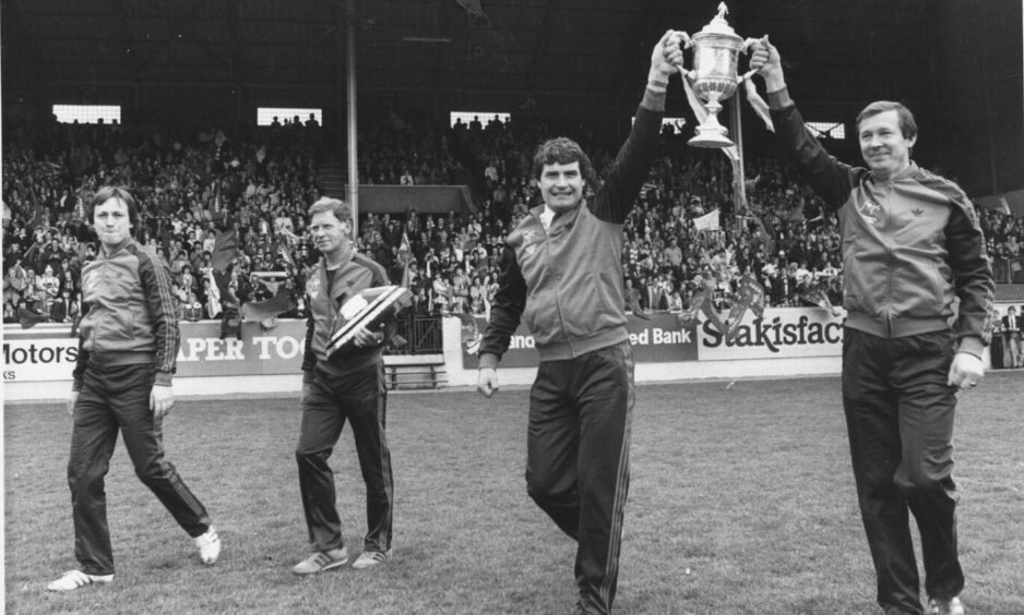 Dons assistant manager Archie Knox and manager Alex Ferguson carry the cup following the Scottish Cup final win over Rangers in 1982.