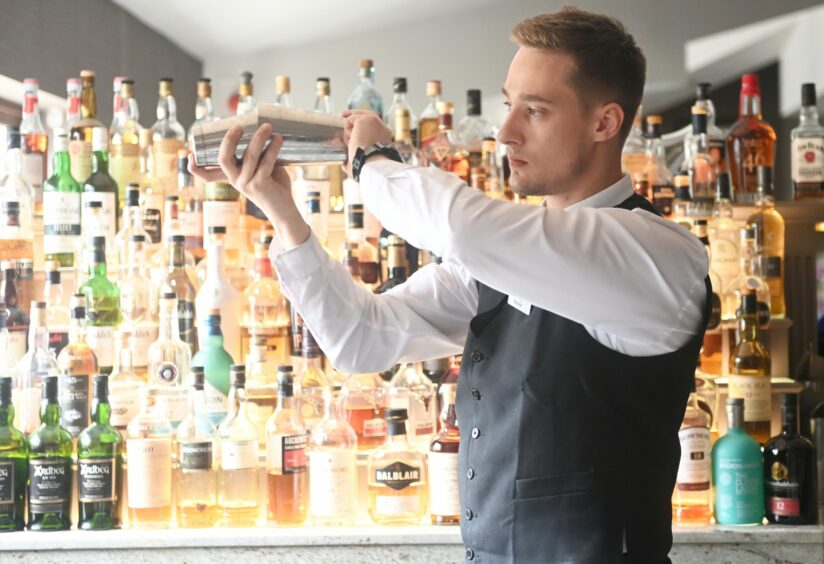 Marcliffe bartender shaking a cocktail.