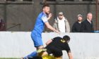Turriff United's new signing Ewan Clark, in blue, pictured in action for Rothie Rovers
