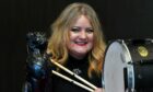 Mairi Newberry holding her drumsticks and drum