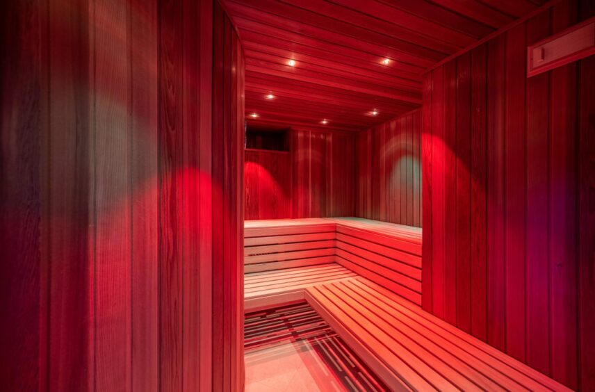A swedish style sauna, lit in red