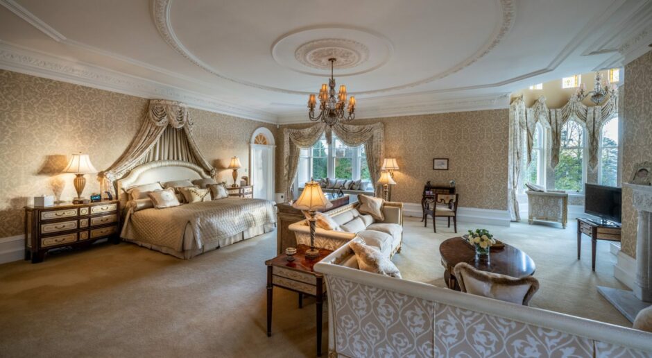 The Bieldside home's main bedroom is soft cream with a large seating area and fireplace