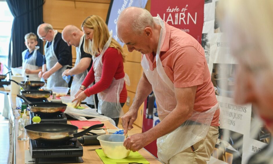 Competitors in a line preparing recipes at World Tattie Scone Championships