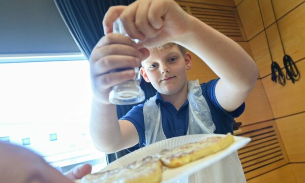 Tom Rhind, 10, competes in World Tattie Scone Championship. Picture by Jason Hedges.