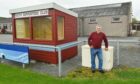 Keith groundsman John Troup pictured at Kynoch Park with the club's new solar panels behind on the roof of the club's function hall.