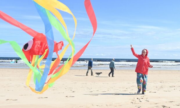 Enjoying the sun on East Beach. Picture by Jason Hedges.