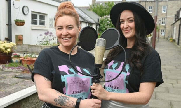 Dawn Farmer and Laura Mears-Reynolds outside Fittie holding their podcasting mics