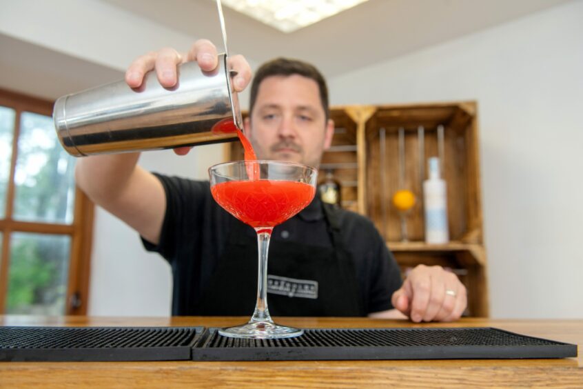 Man pouring cocktail at Reynolds Corporate and Cocktail.
