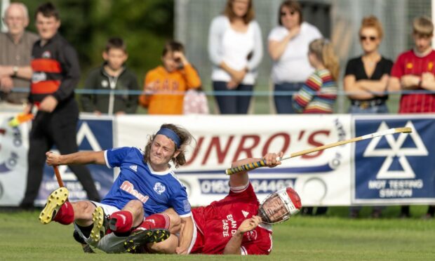 Andrew King (Kyles) with Ali Nixon (Kinlochshiel) in the semi final of the Tulloch Homes Camanachd Cup.