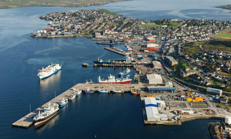 Lerwick Harbour seen from above showing berths and ferries arriving and departing.