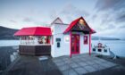 Crannog Restaurant, with its distinctive red roof, has stunning harbour views.