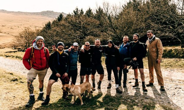 A team of eight men from charity Man Down Cornwall are trekking the UK's largest peak carrying an 82kg hardwood log to help end the stigma around mental health among men.