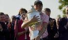 Justin Thomas holds the Wanamaker Trophy after winning the PGA Championship golf tournament in a playoff against Will Zalatoris at Southern Hills Country Club.