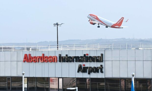 easyJet plane flies over Aberdeen Airport