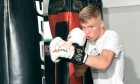 Boxer Ben Bartlett punching a punching bag