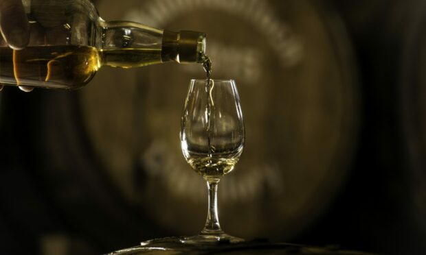 Whisky being poured into glass.