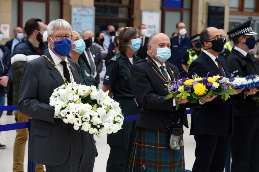 Bill Howatson and Lord Provost of Aberdeen Barney Crockett at the minute's silence held at Aberdeen Railway Station to pay tribute to the victims of the Stonehaven derailment. Picture by Kenny Elrick