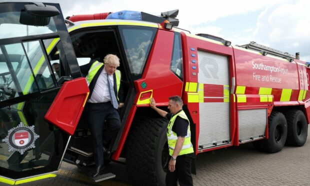Prime Minister Boris Johnson gets off a vehicle of the Southampton airport fire and rescue crew during a visit to the Eastleigh constituency, while on the local elections campaign trail. Picture via PA