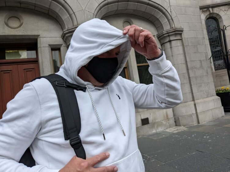 Ross Campbell changed his clothes and covered his face to avoid photographers outside Aberdeen Sheriff Court after a previous appearance.