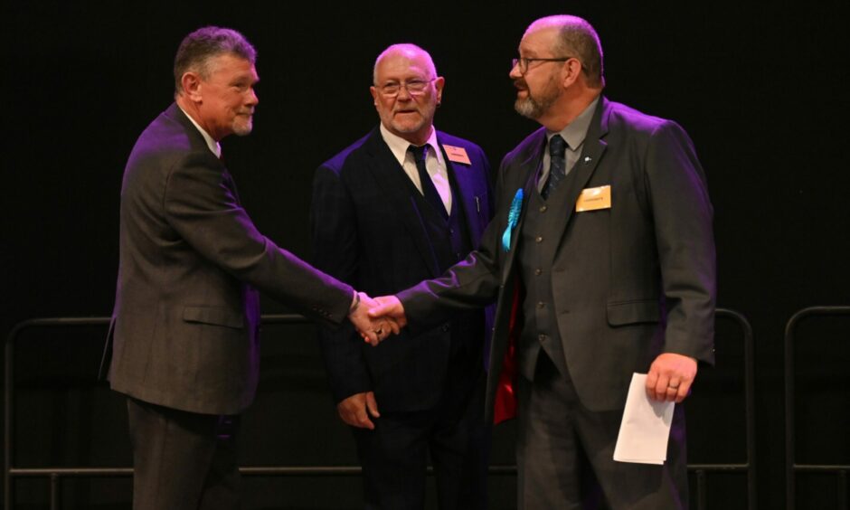 Ross Cassie, Richard Menard, New Aberdeenshire Council Conservative leader Mark Findlater shakes hands with the SNP's Ross Cassie, as both - and fellow Tory Richard Menard - were elected to serve Troup. Picture by Scott Baxter/DCT Media.