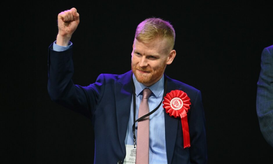 Aberdeen Labour deputy leader Ross Grant punches the air in celebration after defending his Tillydrone, Seaton and Old Aberdeen council seat. Picture by Scott Baxter/DCT Media.