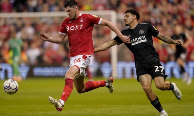 Nottingham Forest's Scott McKenna battles for the ball with Sheffield United's Morgan Gibbs-White.