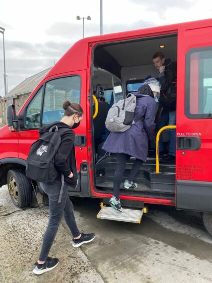 Papay students board the bus to take them to school from the ferry on Westray