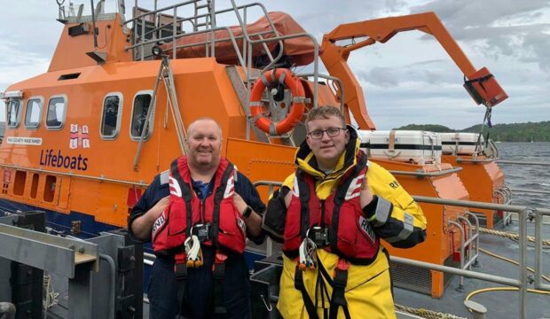 A schoolboy has joined the crew of the RNLI: Bobby MacLeod Gunn (right) with dad 'Gunny' Gunn.