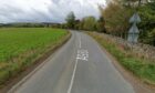 A section of the A980 was closed and a woman was taken to hospital following a two-vehicle crash.