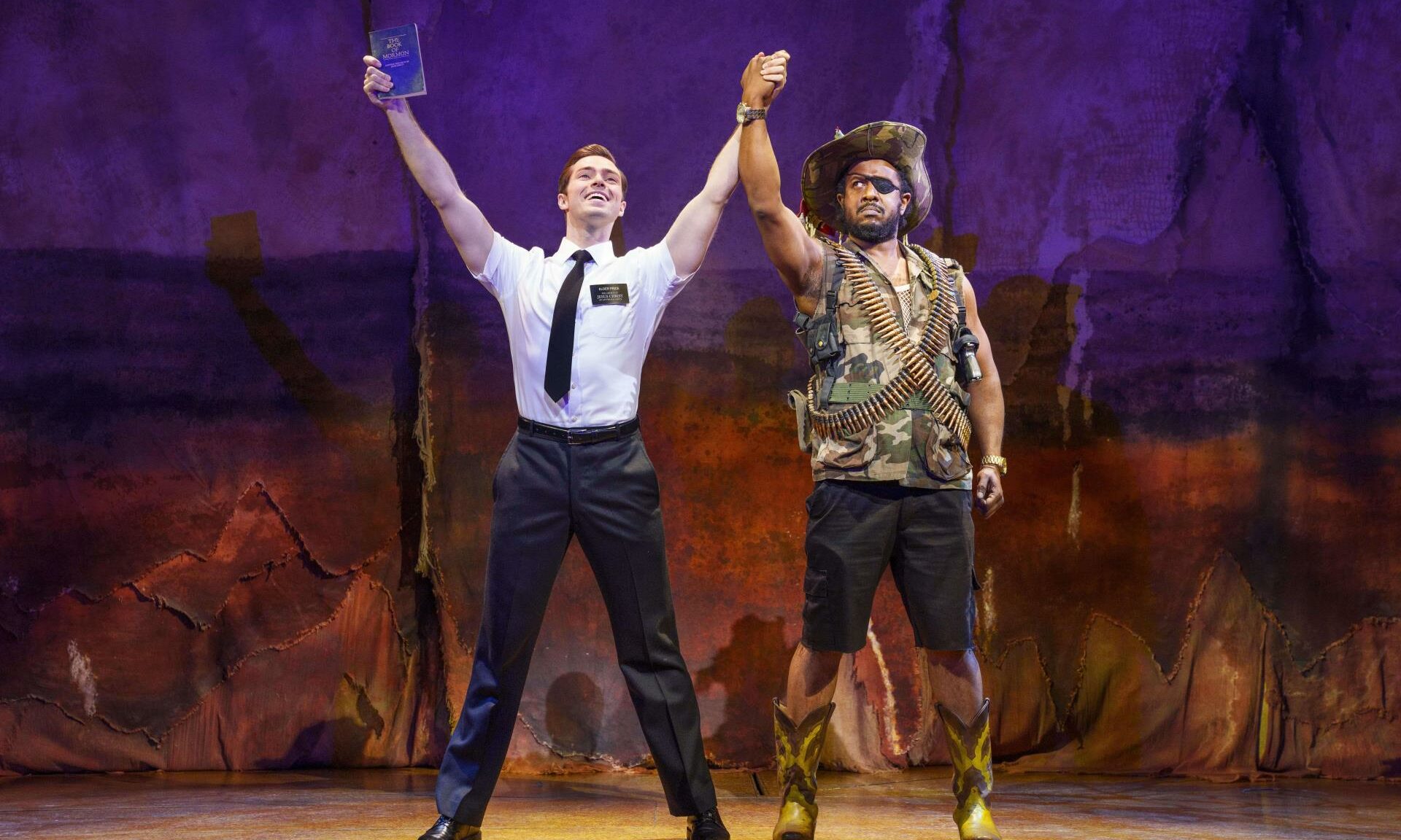 Two actors from The Book of Mormon on stage.