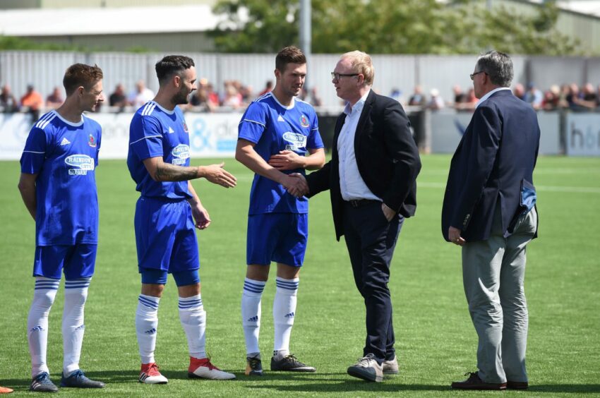 Alex McLeish meets Cove Rangers players at the opening of the Balmoral Stadium in 2018