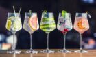 A line of cocktail glasses on a bar