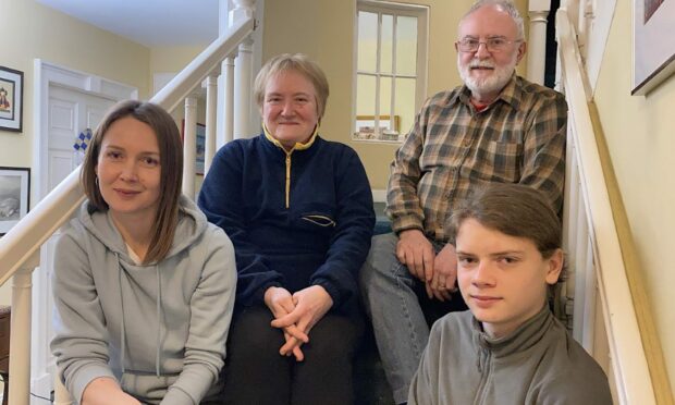 The family has to wait "unnecessarily" long for a UK account. Pictured: Tetiana Safronova (left) and her son Serhii Vladimirov with their sponsors Helen and Tony Erwood at their home at Lunna, in Shetland. Photo: Hans J Marter/Shetland News