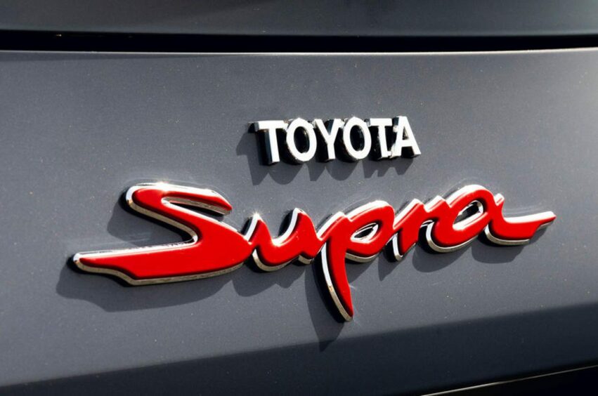 The Toyota Supra logo on the car