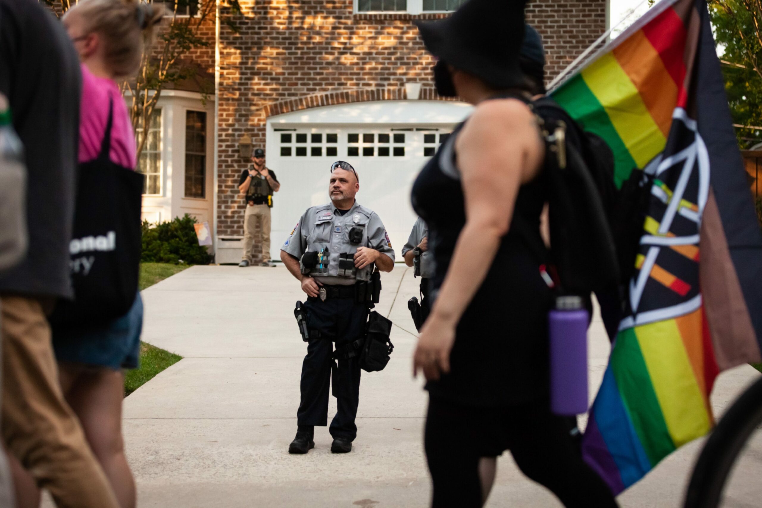 A Fairfax County Police officer watches as pro-choice protesters walk past Supreme Court Justice Samuel Alito's house in Alexandria, VA. Photo by Allison Bailey/NurPhoto/Shutterstock (13008122j)