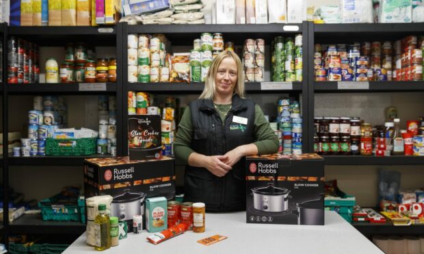 Alison McLennan, a volunteer for Aberdeenshire North Foodbank with a slow cooker pack.
