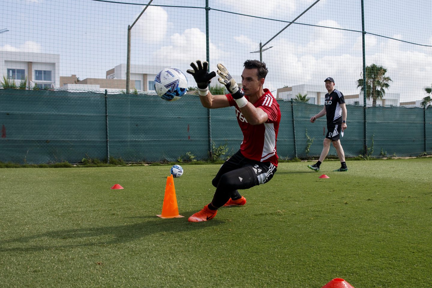Keeper Kelle Roos dives to save during training in Spain.