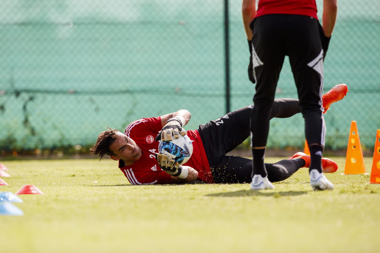 Aberdeen keeper Kelle Roos dives for the ball during training.