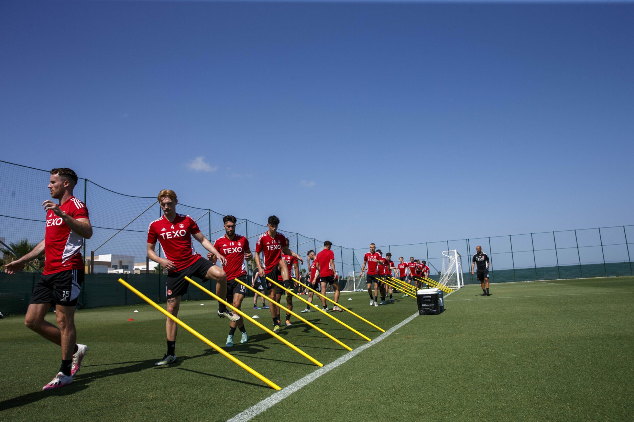 Aberdeen players are put through their paces under the sun in Spain.