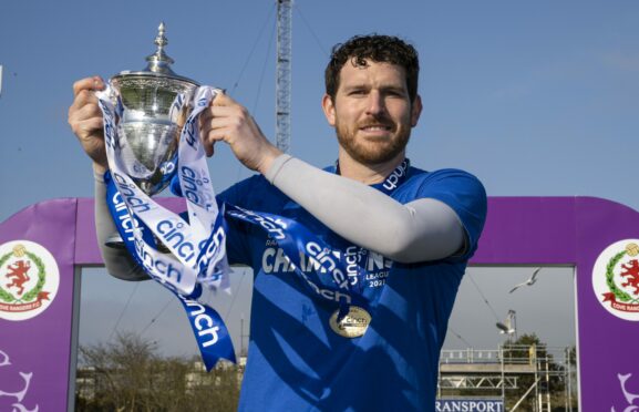 Cove's Stuart McKenzie with the League One trophy. Photo by SNS