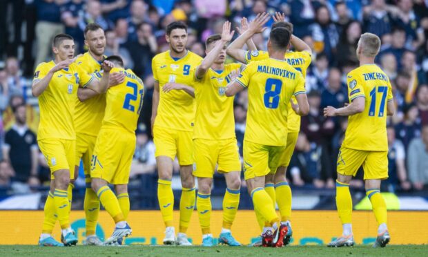 The Ukraine squad celebrate as Andriy Yarmelenko makes it 1-0 against Scotland at Hampden.