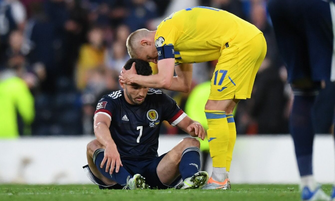 Scotland's John McGinn is consoled by Ukraine's Oleksandr Zinchenko after World Cup play-off semi final loss.