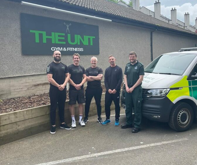 The Unit staff with Aberdeen Ambulance Stadion clinical team leader standing next to an ambulance