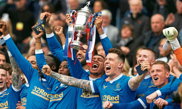 Rangers Captain James Tavernier lifts the Scottish Cup Trophy during the Scottish Cup Final match between Rangers and Hearts at Hampden Park, on May 21, 2022, in Glasgow, Scotland.