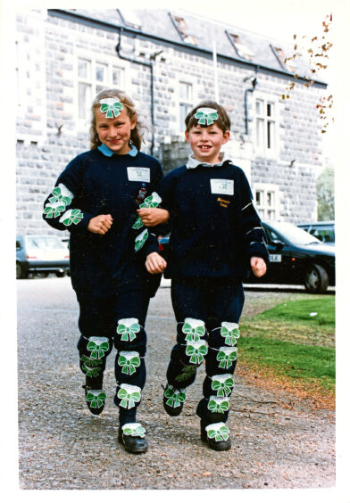 Camilla Lee and Jake Stotley of Blairmore School covered in green Macmillan ribbons in 1993